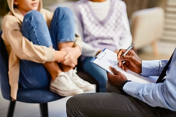 therapist talking to a young girl