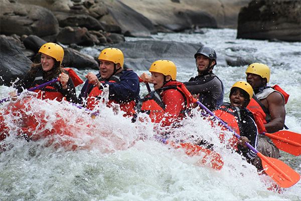 a group of people white water rafting